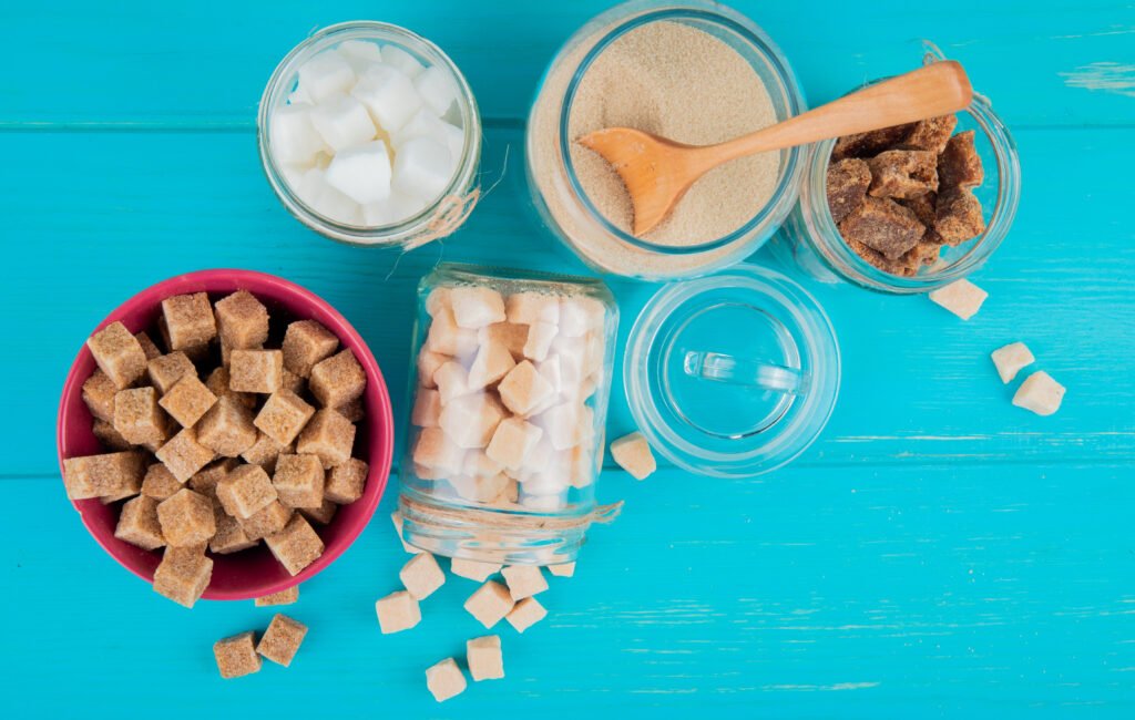 top view of different types of sugar in bowls and in glass jars on blue wooden background Frozen Dog Food: A Comprehensive Guide to Healthier, Happier Pets